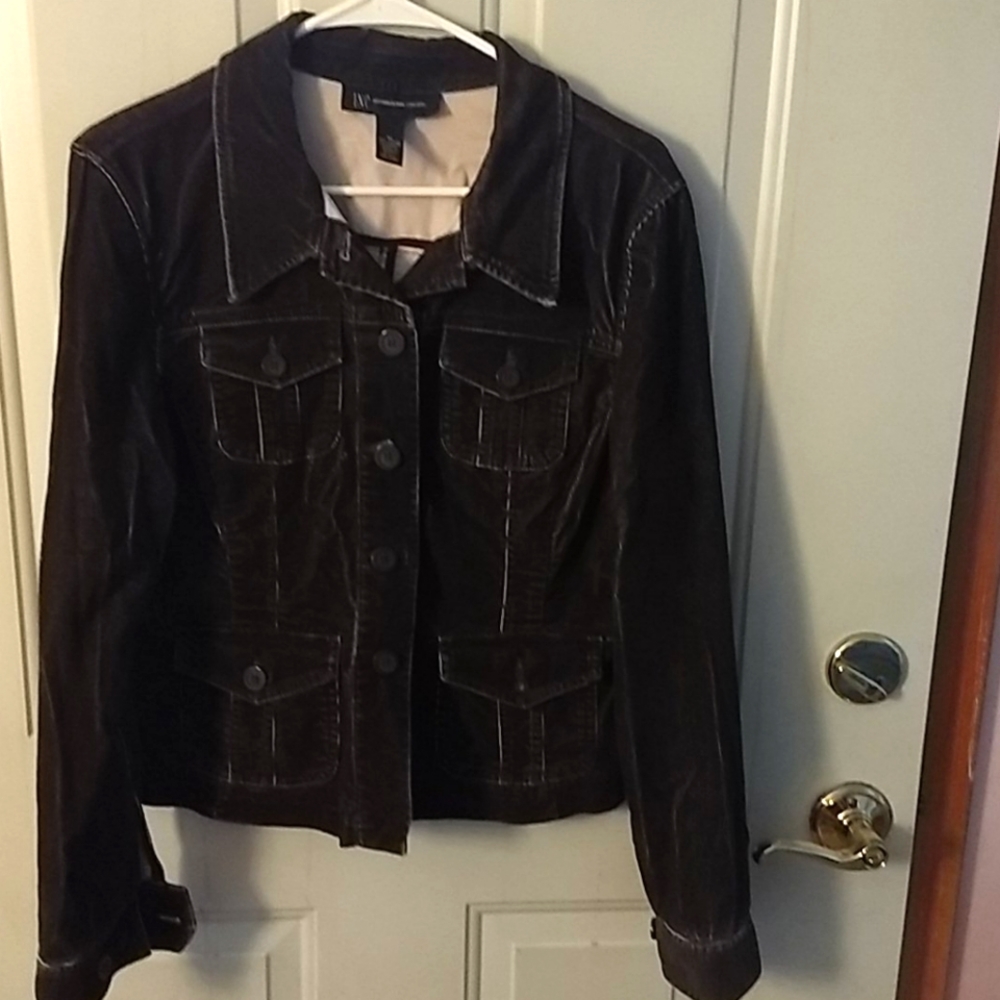 Black denim jacket with white running through it.